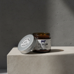 A picture of T's Tallow Whipped balm on a stone pedestal