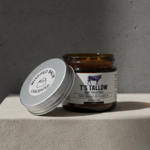 A picture of T's Tallow Whipped balm on a stone pedestal