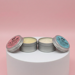 one sweet orange tallow balm and unscented tallow balm on a stone pedestal
