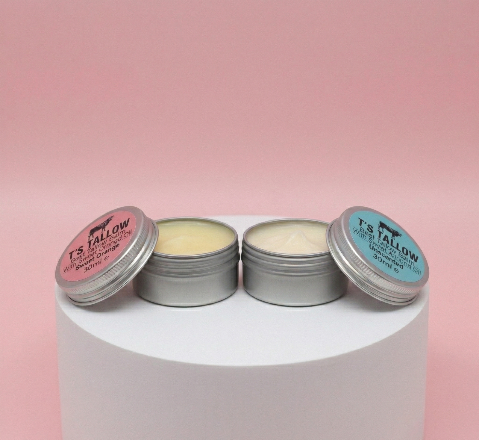 one sweet orange tallow balm and unscented tallow balm on a stone pedestal