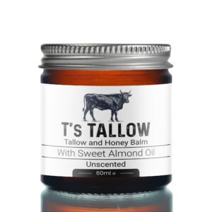 Close-up of a bottle with a metal cap; the label features a cow illustration and reads “It’s Tallow,” “Tallow and Honey Balm,” “With Sweet Almond Oil,” “Unscented,” and “60 ml.”