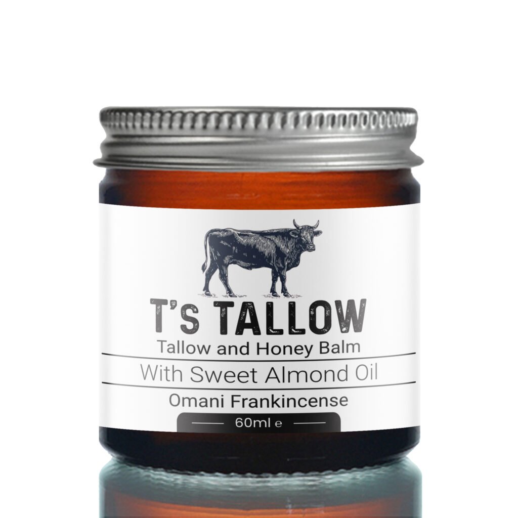 Close-up of a bottle cap and label featuring a cow illustration and the words 'It's Tallow' and 'Talllow and Honey Balm' with almond oil.