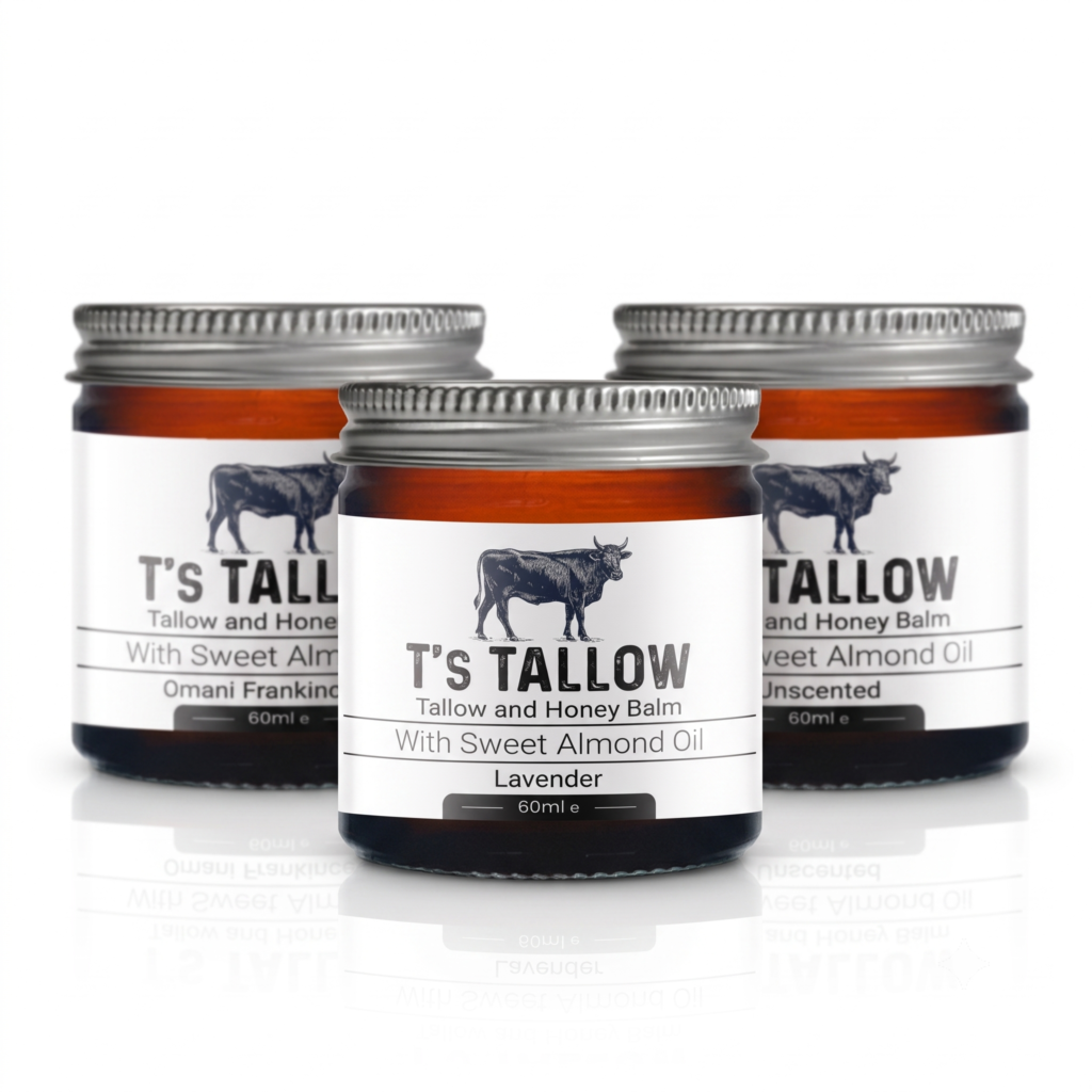 Three balm jars with metal lids, white labels featuring a cow silhouette and the text 'T'S TALLOW' and 'Tallow and Honey Balm' (Lavender).
