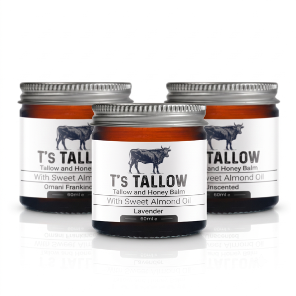 Three balm jars with metal lids, white labels featuring a cow silhouette and the text 'T'S TALLOW' and 'Tallow and Honey Balm' (Lavender).